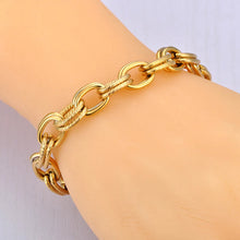 Load image into Gallery viewer, Make a bold statement with this oval circle handmade chain bracelet, meticulously crafted with alternating notched links for added texture and style. Plated in luxurious 18K gold, this stunning piece exudes sophistication and elegance, while the stainless steel construction ensures it remains waterproof and tarnish-free for lasting beauty. Perfect for any occasion, this eye-catching bracelet offers both durability and fashion-forward design, making it a versatile accessory for daily wear or special events.
