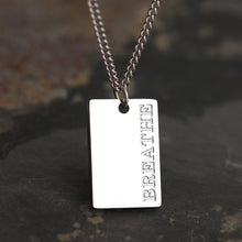 Load image into Gallery viewer, This simple and elegant stainless steel necklace comes in two colours: silver and gold. Its very simple and elegant design is additionally adorned with a rectangle pendant. Pendant has engraved messages of love and support: &quot;Love each other more&quot;, &quot;Always&quot;, &quot;More self love&quot;, &quot;The world is yours&quot; and &quot;Breathe&quot;. This necklace is a perfect gift for your loved ones. The necklace has a lobster clasp.
