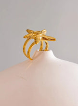 Load image into Gallery viewer, Embrace the essence of summer with this stainless steel starfish open ring, a playful and elegant accessory perfect for your holiday look. 18K gold plated for a luxurious finish, this adjustable ring features a charming starfish design that brings a touch of the ocean to your style. Crafted for durability and comfort, it’s an ideal piece for those who love personalized, summer-inspired jewelry.
