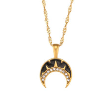 Load image into Gallery viewer, This very elegant pendant necklace is made out of 18K gold plated stainless steel. Pendant is in a shape of a moon and it comes in two colours: black or white. The moon is additionally adorned with a line of cubic zirconia. Necklace can be combined with an elegant dinning outfit and it can be a perfect gift for a special one. It has a size adjustable lobster clasp.&nbsp;
