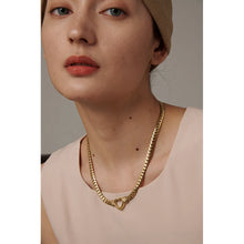 Load image into Gallery viewer, Stainless steel 18K gold plated necklace comes in a gold and silver colour. It is made of a thick and big chain which is adorned with a heart contour in the middle. This luxurious necklace is perfect accessory for any evening gown. It has lobster clasp and adjustable length.
