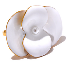 Load image into Gallery viewer, This exquisite adjustable ring showcases a delicate white enamel flower, set on durable, waterproof stainless steel for a chic yet enduring design. With its elegant floral detailing, this ring adds a refined, feminine touch to any outfit, embodying a timeless yet fashion-forward aesthetic. Perfect for daily wear or special occasions, it’s a versatile piece that complements any style. 
