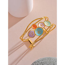 Load image into Gallery viewer, Make a bold statement with our gold-plated stainless steel colorful enamel open angle, designed for fashionable women who love eye-catching accessories. This stylish bangle features an exaggerated, large design adorned with five vibrant enamel circles in red, purple, turquoise, green, and pink, adding a playful splash of color to any outfit. Perfect for making a statement at any occasion, this chic and modern bracelet is a must-have for those who want to stand out with elegance and creativity.
