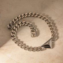 Load image into Gallery viewer, Make a bold yet understated statement with this luxury stainless steel Cuban chain geometric triangle necklace. Featuring a sleek triangle pendant paired with a classic Cuban chain, this unisex piece blends modern design with timeless appeal. Crafted from durable stainless steel, it offers a stylish, tarnish-resistant finish perfect for everyday wear or special occasions. 
