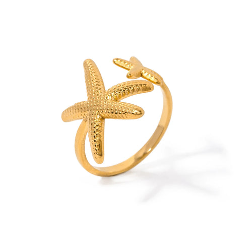 Elevate your summer ensemble with this stunning gold-plated stainless steel ring, designed in a radiant gold hue. The ring features two intricately detailed starfish, one larger and one smaller, symbolizing the beauty and charm of the ocean. Its elegant design makes it the perfect accessory to complement any summer outfit, adding a touch of coastal flair to your look. The adjustable sizing ensures a comfortable fit for anyone, making it an ideal gift for yourself or someone special. Whether you're strolling