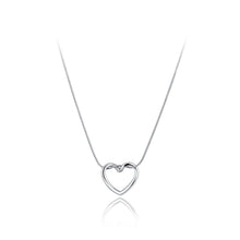 Load image into Gallery viewer, Stainless steel necklace comes in two colours: gold and silver. This simple and elegant necklace is adorned with a twisted hollow heart pendant. It is a perfect piece for an elegant occasion outfit as well as for daily combinations. The necklace has a size adjustable chain with a lobster clasp.&nbsp;
