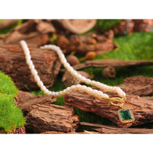 Load image into Gallery viewer, This romantic and luxurious necklace is made of natural freshwater pearls and stainless steel components. The necklace is adorned with a nice green stone circled with golden border and cubic zirconia.  There is a toggle clasp above the stone which is also adorned with cubic zirconia. Necklace is perfect accessory for any evening outfit. 
