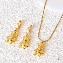 Load image into Gallery viewer, Add a playful touch to your style with these stainless steel gold color bear pendant earrings. Plated in radiant gold, these charming earrings feature adorable bear pendants that bring a fun yet sophisticated flair to any outfit. Durable and lightweight, they&#39;re perfect for everyday wear or as a delightful holiday gift. A unique and stylish addition to any jewelry collection!
