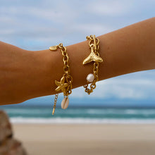 Load image into Gallery viewer, Add a touch of seaside charm to your look with this Summer Stainless Steel Fishtail and Star Charm Bracelet. Plated in radiant 18K gold and designed with a delicate drop chain, this stylish bracelet features playful fishtail and pearl charms that capture the essence of summer. Waterproof and durable, it&#39;s perfect for everyday wear, whether you&#39;re at the beach or adding a touch of whimsy to your daily outfit.
