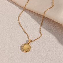 Load image into Gallery viewer, Stainless steel gold plated necklace is made of an elegant and thin chain. There is a round pendant which is adorned with a moon and a star. Both, the moon and the star are made of transparent cubic zirconia. This necklace is a perfect piece for an elegant occasion outfit. It has lobster clasp and adjustable length.
