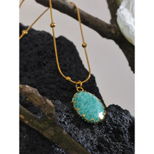 Load image into Gallery viewer, Stainless steel 18K gold plated necklace comes in a gold colour. It is made of a beautiful chain adorned with small balls. It has oval pendant made of natural stone amazonite with nice gold border. The chain necklace is perfect for spicing up your summer outfit. It has lobster clasp and adjustable length.
