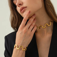 Load image into Gallery viewer, This elegant wave choker necklace features a striking wave design at the front, crafted from stainless steel with a radiant gold-plated finish for a modern, sophisticated look. The adjustable length and long, graceful chains at the back add versatility and a touch of drama. Perfect as a bold statement piece or a thoughtful gift, this necklace enhances any outfit with its unique charm and elegance.
