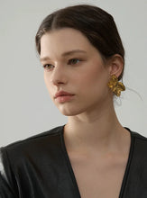 Load image into Gallery viewer, These bold flower stud earrings, crafted from waterproof stainless steel in a radiant gold color, feature large, eye-catching petals that make a high-quality fashion statement. Their oversized floral design offers a touch of elegance and femininity, perfect for adding flair to any outfit. Durable and beautifully crafted, these earrings are ideal for women who appreciate stylish, standout accessories. 
