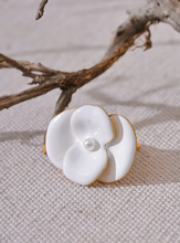 Load image into Gallery viewer, This exquisite adjustable ring showcases a delicate white enamel flower, set on durable, waterproof stainless steel for a chic yet enduring design. With its elegant floral detailing, this ring adds a refined, feminine touch to any outfit, embodying a timeless yet fashion-forward aesthetic. Perfect for daily wear or special occasions, it’s a versatile piece that complements any style. 
