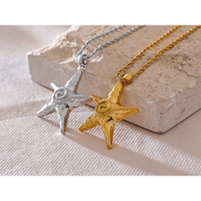 Load image into Gallery viewer, Elevate your summer style with this stunning statement necklace, available in both silver and gold tones. Expertly crafted from durable stainless steel with a luxurious gold plating, this piece features a long, intricate wheat chain that adds a touch of sophistication. The showstopper is the bold starfish pendant, beautifully embellished with a carved spiral detail, evoking the charm of seaside adventures. Complete with a secure lobster clasp and an adjustable length
