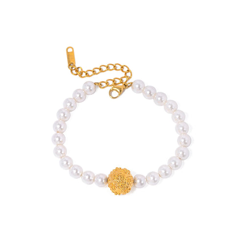 This elegant, vintage-inspired bracelet is crafted from lustrous pearls and features a striking gold-tone hammered stainless steel ball, adding a touch of timeless sophistication. The intricate detailing of the embossed ball beautifully complements the classic pearl design, making this bracelet the perfect accessory for any glamorous or elegant outfit. Finished with a secure lobster clasp and an adjustable chain, it ensures a comfortable and customizable fit. 