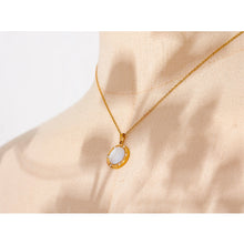 Load image into Gallery viewer, Stainless steel delicate necklace comes in a gold colour. It is made of fine and thin link chain and it has beautiful round pendant . Pendant is made of natural shell and it is circled with a fine golden border. It is also additionally adorned with small zircons which gives the necklace chic and stylish look. This necklace can be worn with any daily outfit. It has lobster clasp and adjustable length.
