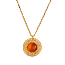 Load image into Gallery viewer, This luxurious necklace is made of stainless steel, and it is real gold plated. It comes in three different options: red, white, or turquoise stone. It has very luxurious chain which is adorned with a nice medallion with a stone in the middle. The golden hem has interestingly carved surface which makes this necklace a great accessory for evening night out. It has a adjustable length and lobster clasp. 
