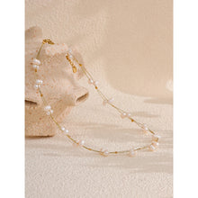 Load image into Gallery viewer, This beautiful handmade necklace, crafted from stainless steel, features a delicate double chain design that exudes elegance and sophistication. The thin chains are adorned with shimmering golden cubes and natural freshwater pearls, creating a striking balance of modern charm and timeless grace. Perfect for glamorous occasions, this necklace adds a touch of refined class to any ensemble.
