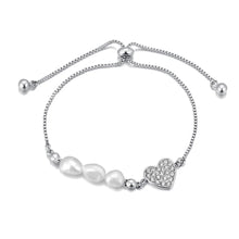 Load image into Gallery viewer, Add a touch of elegance to your look with this stainless steel heart charm bracelet. Adorned with natural pearls and a sparkling zircon heart pendant, and finished with 18K gold plating, this bracelet exudes timeless sophistication. Perfect for women who love graceful and versatile accessories, it’s a stunning piece for both everyday wear and special occasions. A thoughtful gift or a chic addition to any jewelry collection.
