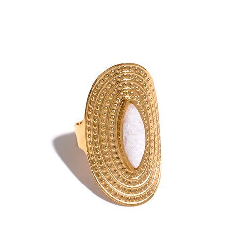 This stainless steel natural stone hyperbolic ring is a stylish statement piece perfect for a bold, bohemian look. Featuring a smooth, white natural stone (white agate) center set within a gold-toned, notched wide border, it captures a blend of elegance and modern edge. Designed with summer vibes in mind, this adjustable ring pairs well with casual or dressy outfits, adding a unique, eye-catching touch to any style.