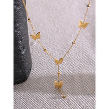 Load image into Gallery viewer, This beautiful and elegant 18K plated stainless steel necklace comes in a gold colour. It is adorned with small cubic zirconia pendants and stainless steel butterflies. There is a small chain hanging at the bottom of the necklace also adorned with the same pattern. This chic necklace is perfect for spicing up your evening outfit. It has lobster clasp and adjustable length.
