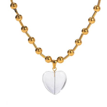 Load image into Gallery viewer, This elegant stainless steel necklace comes in two options, with pink or clear heart pendant. The necklace has a very interesting chain adorned with small stainless steel balls. The heart pendant is made of glass and it makes this necklace a perfect piece for an elegant occasion outfit. The necklace has a lobster clasp and adjustable length. 
