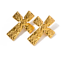 Load image into Gallery viewer, Make a bold statement with these trendy stainless steel cross carved stud earrings. Featuring intricate tribal-inspired carvings, these earrings add a unique, edgy touch to any outfit. Crafted from durable stainless steel, they offer both style and longevity, making them the perfect accessory for those who love standout, statement jewelry.
