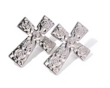 Load image into Gallery viewer, Make a bold statement with these trendy stainless steel cross carved stud earrings. Featuring intricate tribal-inspired carvings, these earrings add a unique, edgy touch to any outfit. Crafted from durable stainless steel, they offer both style and longevity, making them the perfect accessory for those who love standout, statement jewelry.
