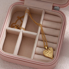 Load image into Gallery viewer, This gorgeous heart pendant necklace is made out of 18K gold plated stainless steel. Heart pedant is adorned with interesting cuts on its surface.The necklace can be perfectly combined with any type of daily or night outfit. It has a size adjustable chain with a lobster clasp. 
