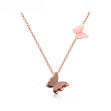 Load image into Gallery viewer, Necklace made of stainless steel comes in two variants: rose gold and silver colour. Necklace is adorned with two beautiful pedants in a shape of a butterfly. The bigger butterfly has one smaller butterfly with sanded surface. The necklace has adjustable length and lobster clasp.
