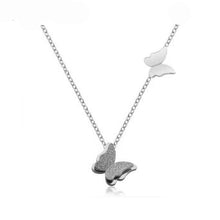 Load image into Gallery viewer, Necklace made of stainless steel comes in two variants: rose gold and silver colour. Necklace is adorned with two beautiful pedants in a shape of a butterfly. The bigger butterfly has one smaller butterfly with sanded surface. The necklace has adjustable length and lobster clasp.
