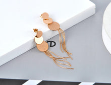 Load image into Gallery viewer, These beautiful earrings are made of stainless steel in a rose gold colour. Earrings have three circles of different sizes, from which two of them have sanded surface. Below three circles earrings are additionally adorned with stainless steel tassel. They make perfect accessory for your evening outfits. Earrings have stud closure.
