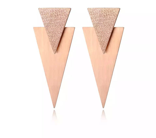 Rock glam stainless steel earrings are made in a rose gold and silver colour. They consists of  two triangles of different sizes. The upper triangle is smaller and sanded while the one situated below is bigger with shiny surface. Earrings are three times gold plated and represent perfect and elegant touch to your day to day style. They have stud fastening.