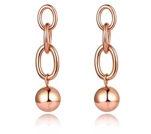 Rock glam stainless steel earrings are made in a rose gold and silver colour. They consists of three chain links. There is a ball at the bottom connected to them. Earrings are three times gold plated and represent great accessory for your rock glam styling. They have stud fastening.