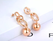 Load image into Gallery viewer, Rock glam stainless steel earrings are made in a rose gold and silver colour. They consists of three chain links. There is a ball at the bottom connected to them. Earrings are three times gold plated and represent great accessory for your rock glam styling. They have stud fastening.
