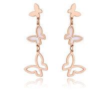 Load image into Gallery viewer, Elegant stainless steel earrings are made in a rose gold and silver colour. They consists of three connected butterflies. Butterflies are connected from the smallest one to the biggest. The smallest one has shiny rose gold surface, the middle one is adorned with white shell and the biggest one represents only butterfly silhouette. Earrings are rose gold plated and represent perfect and elegant touch to your evening outfit. They have stud fastening.
