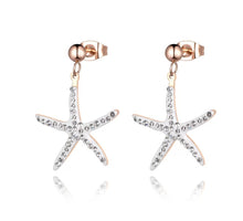 Load image into Gallery viewer, Trendy stainless steel earrings are made in a rose gold colour. They are adorned with starfish that comes in white or black colour. Starfish is made of cubic zirconia and it hangs on a little ball. Earrings are rose gold plated and made great summer accessory. They have stud fastening.
