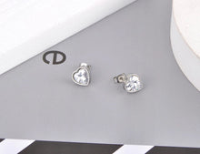 Load image into Gallery viewer, Classy and elegant stainless steel earrings are made in a rose gold and silver colour. The earrings are made in a shape of a heart which is adorned with big cubic zirconia. Earrings are rose gold plated and represent perfect and elegant touch to your classy and smart outfit. They have stud fastening.
