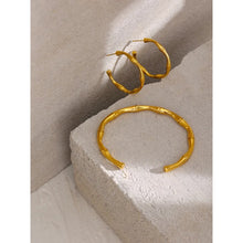 Load image into Gallery viewer, Fashionable hoop earrings are made of stainless steel and come in a gold colour. They have real gold plating and are adorned with a bamboo pattern. Their simplicity and elegance makes them perfect accessory for any outfit. Earrings have stud closure.
