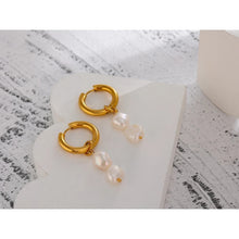 Load image into Gallery viewer, Elegant stainless steel earrings are made in a gold colour. They consists of small hoop on which two natural pearls are hanging. Combination of gold and pearls gives them extra elegant and classy effect. Earrings have real gold plating and represent great accessory to your elegant outfit. They have French lock (hoops).
