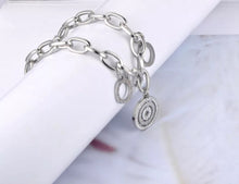 Load image into Gallery viewer, Beautiful stainless steel bracelet is made of a big linked chain and adorned with three circles. Main circle is richly adorned with two circles of cubic zirconia and engraved roman numerals. Other two circles are smaller and have roman numerals around its perimeter. The length is adjustable and bracelet has lobster closure.
