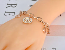 Load image into Gallery viewer, Beautiful stainless steel bracelet is made of a big linked chain and adorned with three circles. Main circle is richly adorned with two circles of cubic zirconia and engraved roman numerals. Other two circles are smaller and have roman numerals around its perimeter. The length is adjustable and bracelet has lobster closure.
