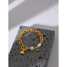 Load image into Gallery viewer, Bracelet is made of stainless steel and has real gold plating. It comes in gold colour and its link chain is adorned with two natural pearls. It has toggle clasp with a little plate. This bracelet is perfect to be warn in any occasion.
