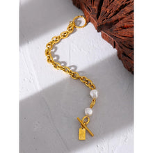 Load image into Gallery viewer, Bracelet is made of stainless steel and has real gold plating. It comes in gold colour and its link chain is adorned with two natural pearls. It has toggle clasp with a little plate. This bracelet is perfect to be warn in any occasion.
