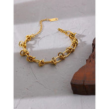 Load image into Gallery viewer, This statement bracelet is made of stainless steel and has real gold plating. It comes in gold colour. Its interesting linked chain makes it perfect accessory for daily and evening outfits. Length is adjustable with lobster clasp.
