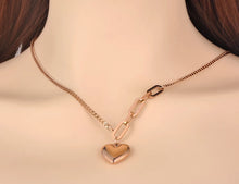 Load image into Gallery viewer, Bohemian necklace is made of stainless steel that is three times gold plated. It is made of link chain. At the bottom of a necklace links are much bigger at one side and makes the whole necklace very interesting. The necklace has a pedant in a shape of a heart which makes this necklace a perfect gift for your loved ones.
