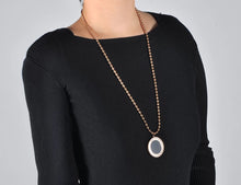 Load image into Gallery viewer, Stainless steel necklace comes in a rose gold and silver colour. It is made of fine beaded chain which is adorned with a statement medallion. Medallion is made of shell and is rotatable. It can be worn on two sides, black and white. The necklace is perfect for daily outfits as well as to light up your night dress. It has lobster clasp.
