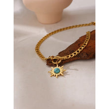 Load image into Gallery viewer, Stainless steel necklace comes in a gold colour and it is three times gold plated. The necklace is made of a thicker link chain which is adorned with a sun pedant and bigger toggle clasp. Sun is adorned with a blue stone that is surrounded with golden rays. This statement necklace is perfect to spice up any outfit. 
