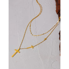 Load image into Gallery viewer, Stainless steel necklace comes in a gold colour and it is three times gold plated. This layered necklace is made of two different, thin and delicate chains with different length. Longer chain is adorned with three crosses in different sizes from which the biggest one is placed at the bottom of the necklace. The chain necklace is perfect for spicing up your daily and evening outfit. It has lobster clasp.
